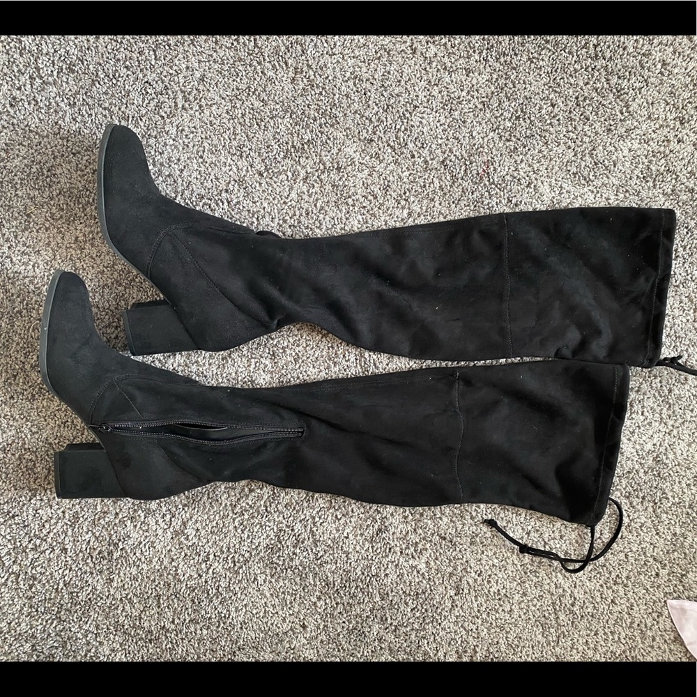 Over the knee black boots.